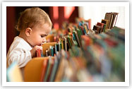 Child looking through books Child looking through books