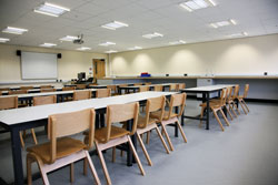 A classroom with desks and tables A classroom with desks and tables