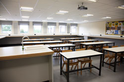 A classroom with tables and a sink A classroom with tables and a sink