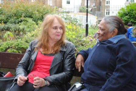 two women talking on a park bench two women talking on a park bench