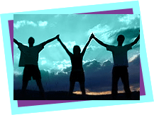 Three people standing in shadows joining hands