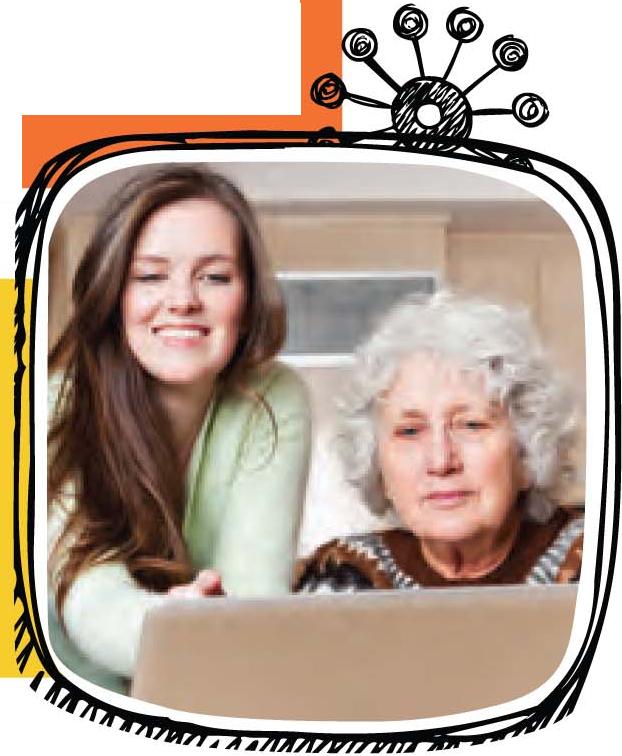 young girl and older woman smiling at computer young girl and older woman smiling at computer