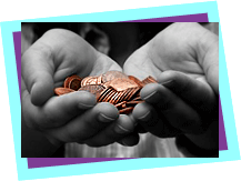 Hands cupped together holding a pile of coins