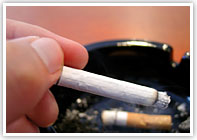 A cigarette and ashtray A cigarette and ashtray