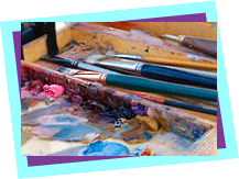 paint brushes and paint in an artist's palette