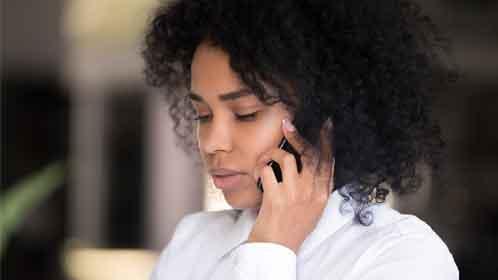 A mixed race woman making a phone call
