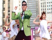 Korean man in sunglasses dancing the gangnam style dance.