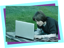 boy using laptop and lying on the grass. boy using laptop and lying on the grass.