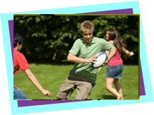 Young people playing rugby in a park Young people playing rugby in a park