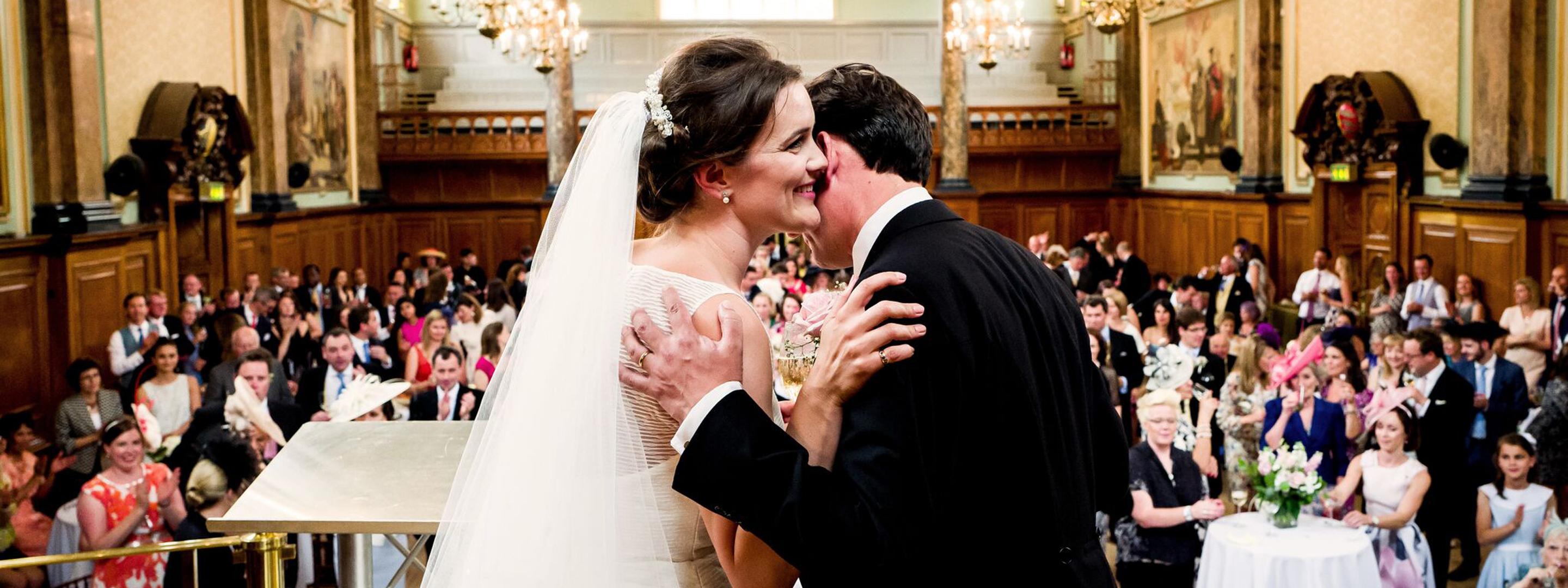 couple getting married in small hall
