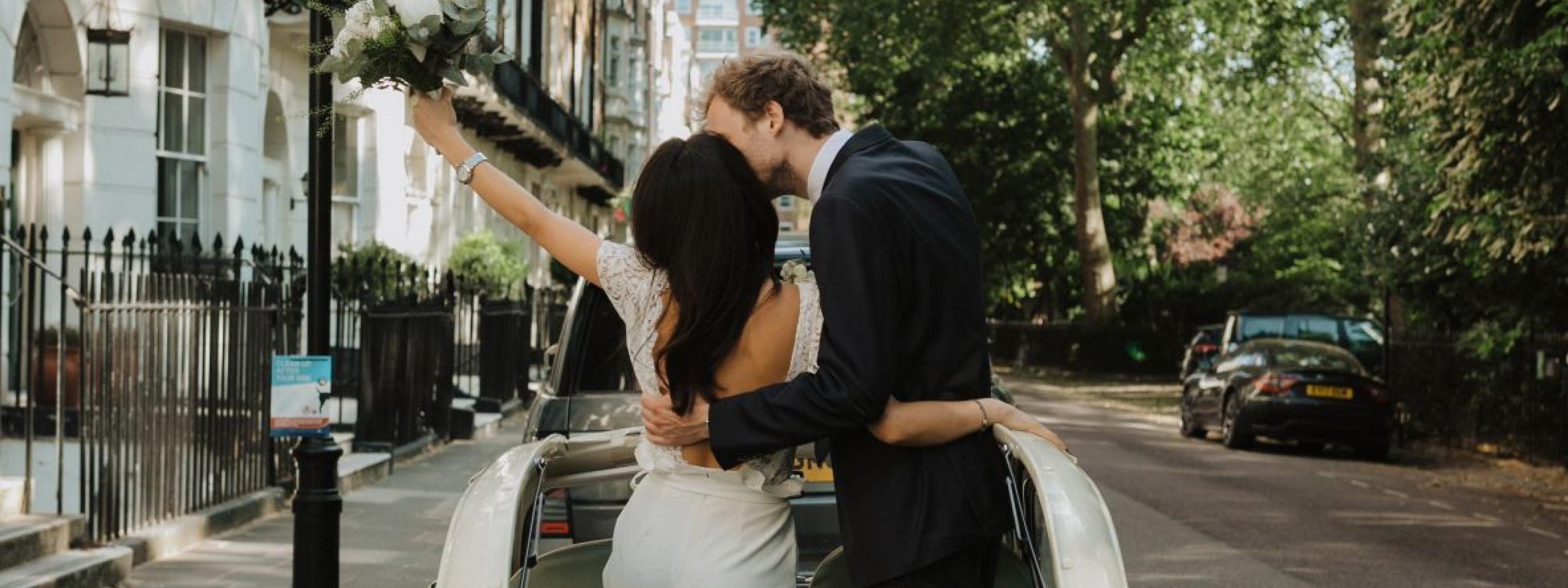 Couple standing through the sunroof of white car