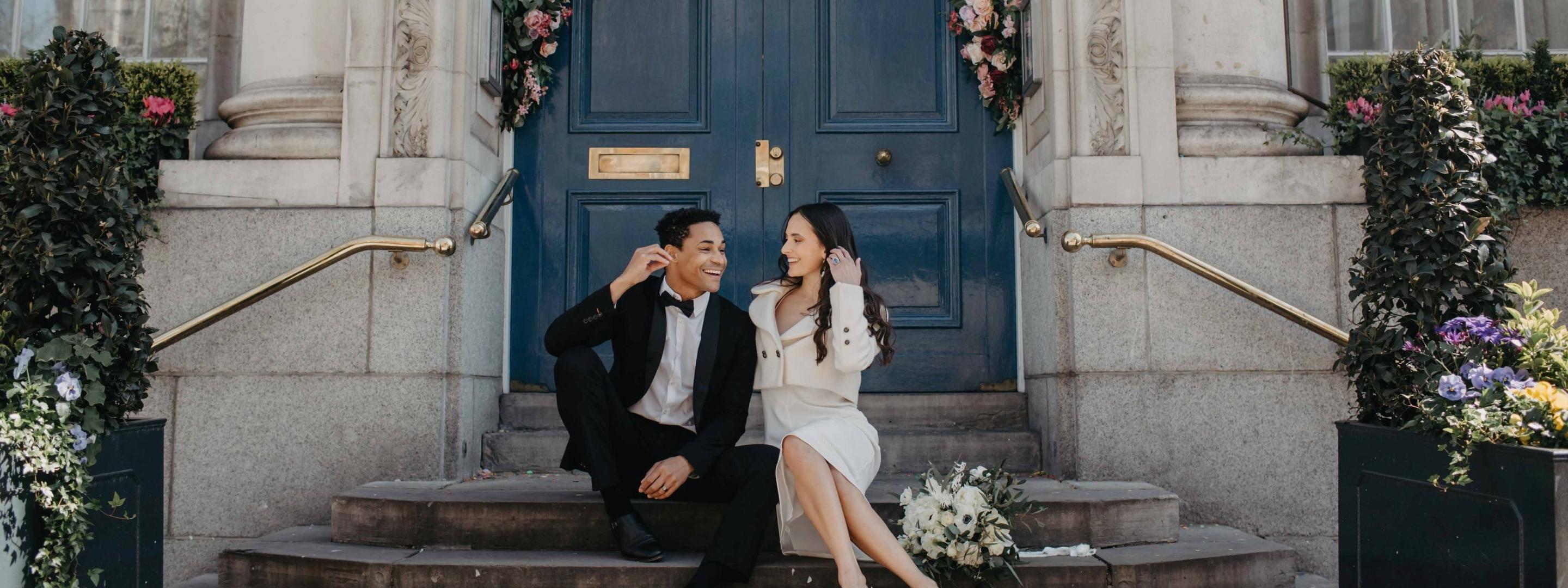 Couple sitting on steps.
