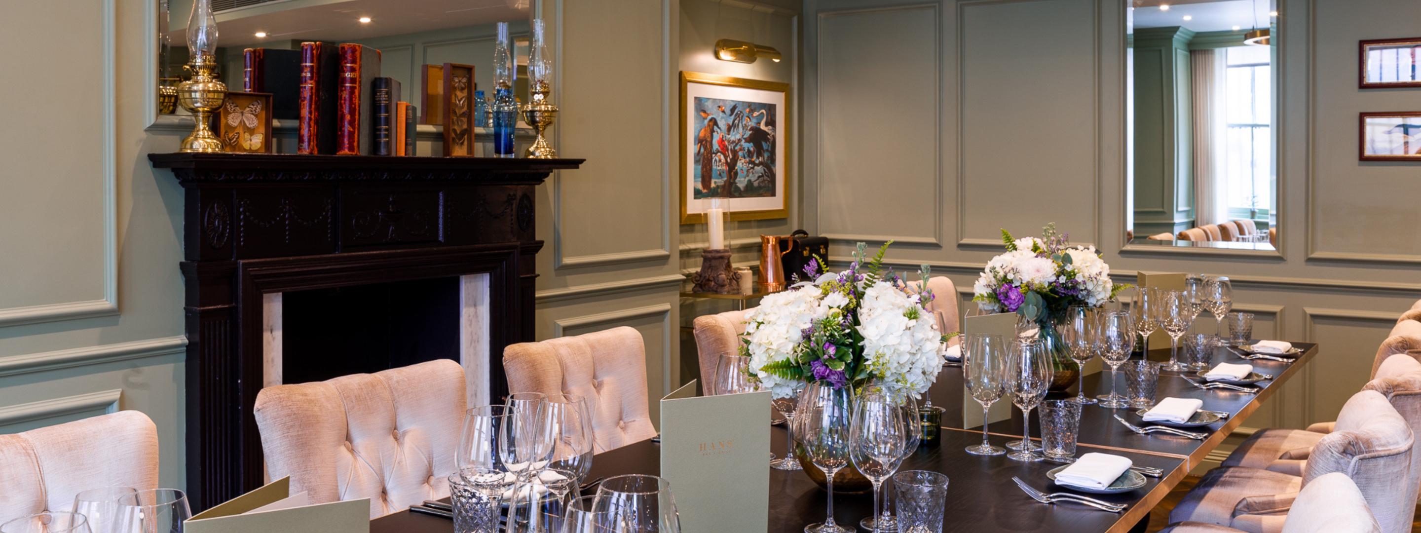 A long table with crockery and chairs