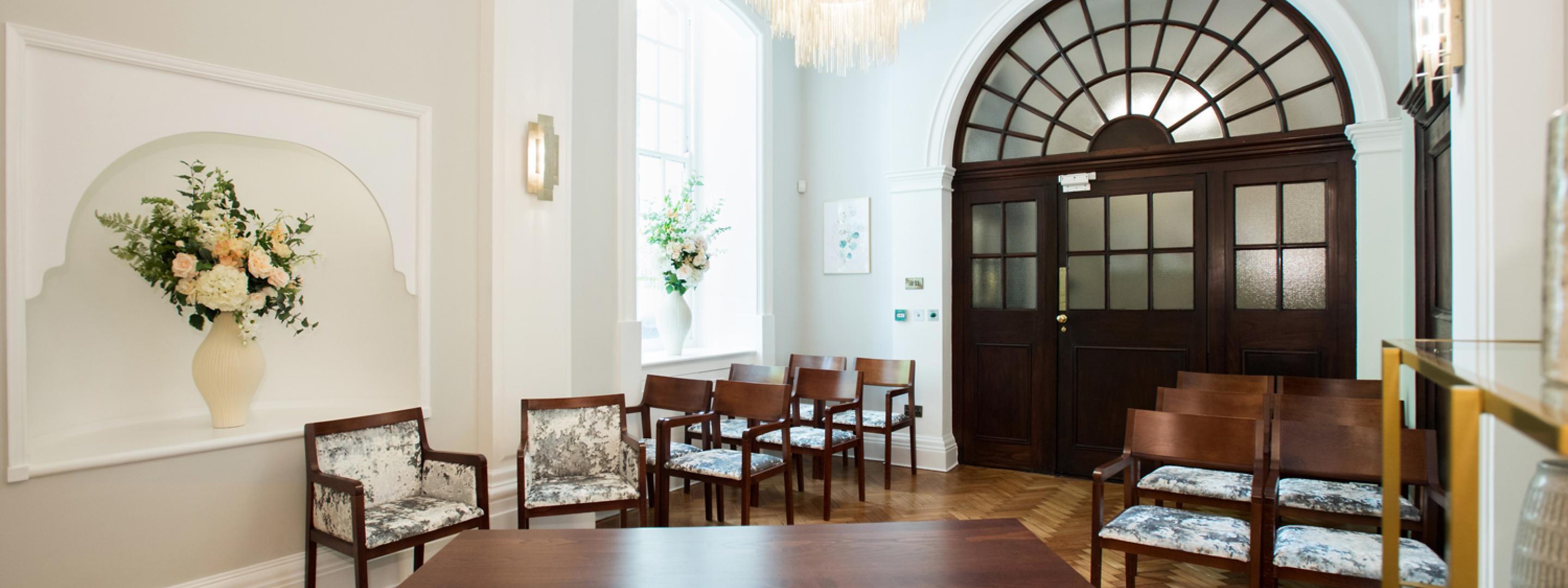 Rear view of Rossetti room showing furniture and glass-panelled door.