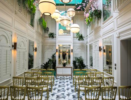 Inside of wedding venue with chairs and decorations laid out.