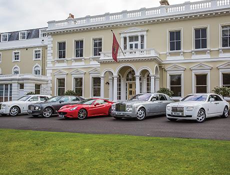 sports cars parked outside a building