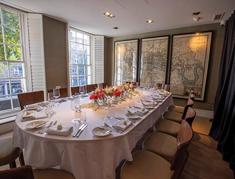 Restaurant table with plates and chairs