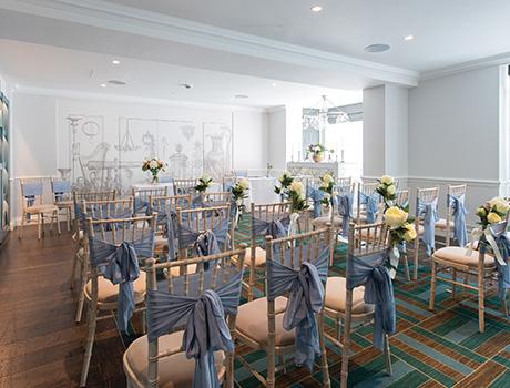 chairs decorated with ribbons and flowers