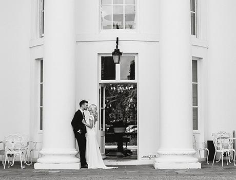 a couple outside a building with tall pillars
