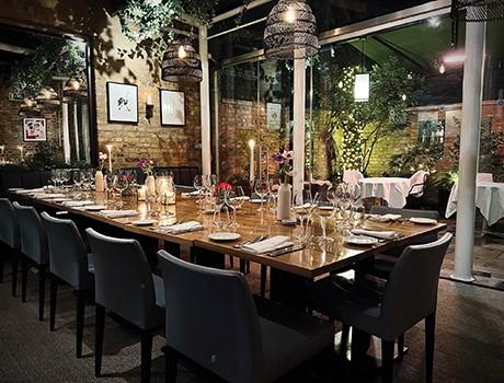 A brown table with chairs underneath