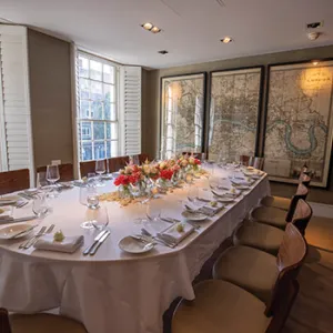 Restaurant table with plates and chairs