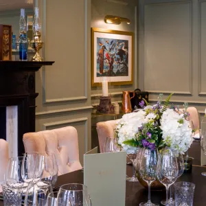 A long table with crockery and chairs