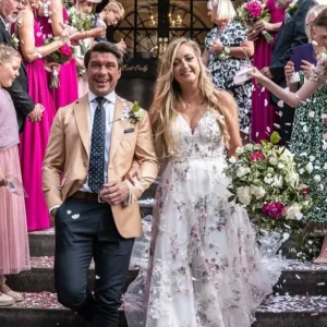 A married couple leave a church