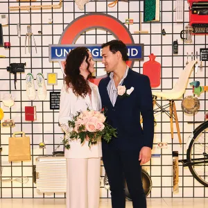 A couple standing in front of a selection of iconic design items