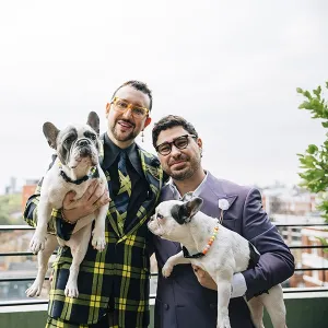 The grooms holding dogs
