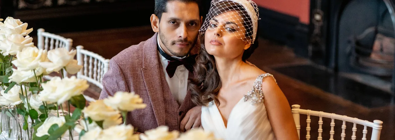 A newly wed man and a woman sitting at a table