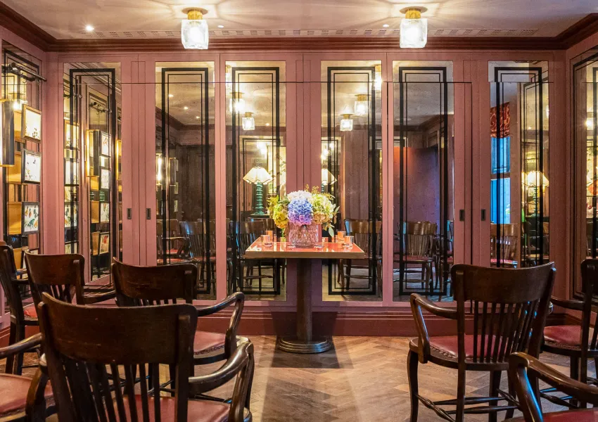 a bar area with tables and chairs