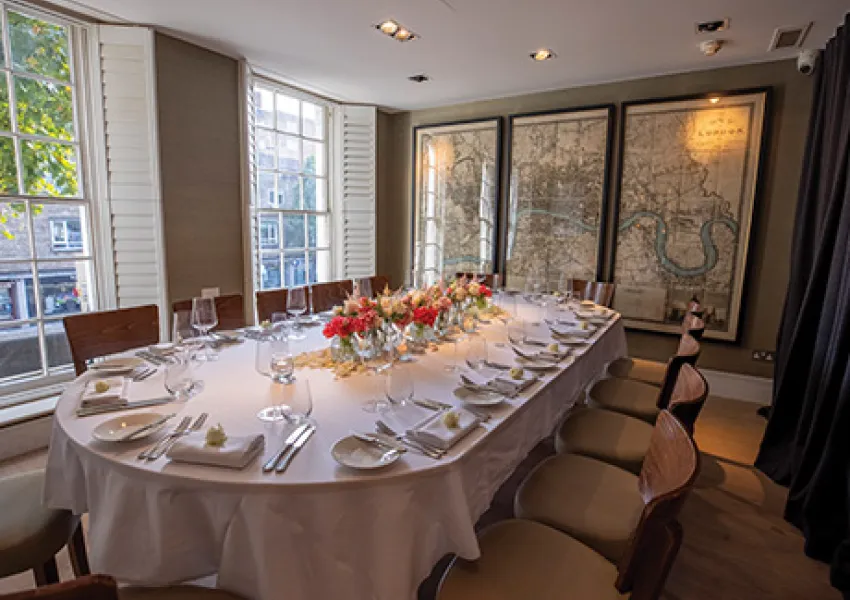 Restaurant table with plates and chairs