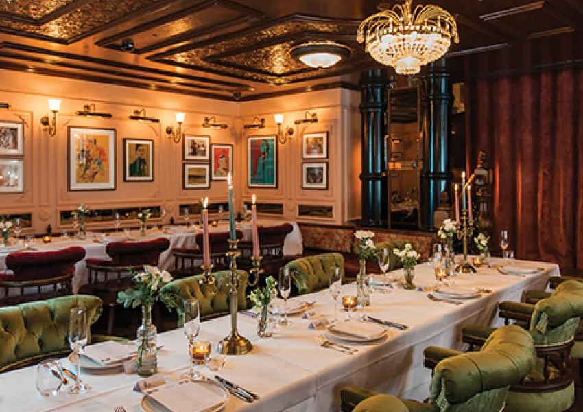 Restaurant table with plates and chairs