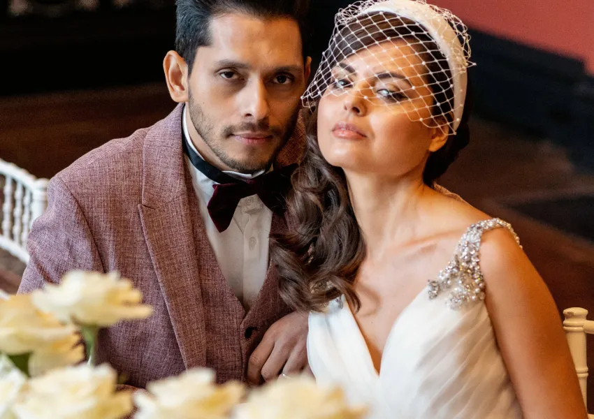 A newly wed man and a woman sitting at a table