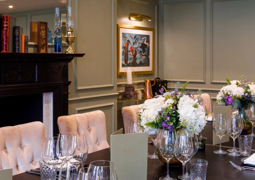A long table with crockery and chairs