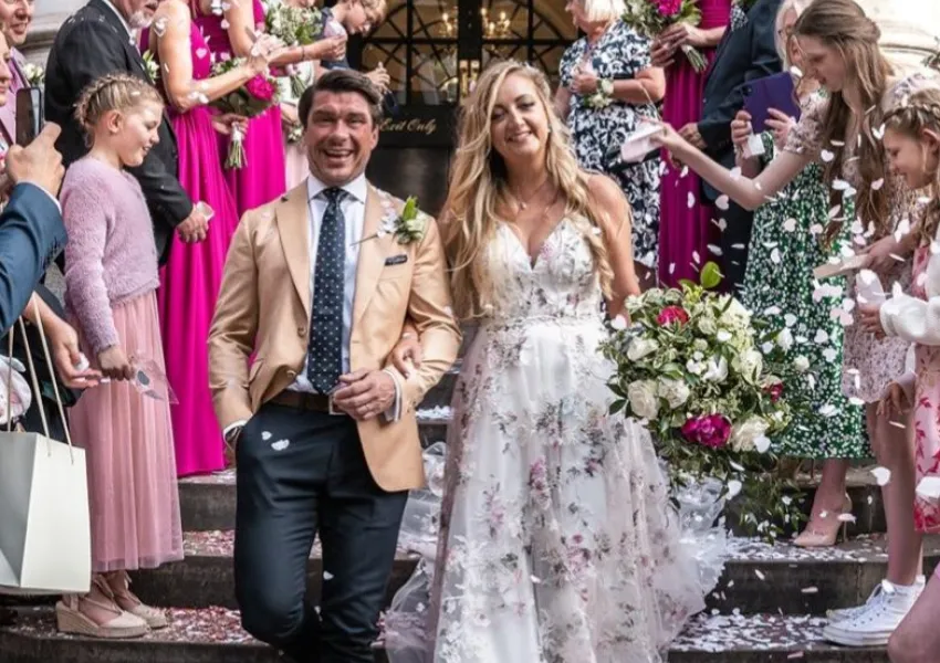 A married couple leave a church