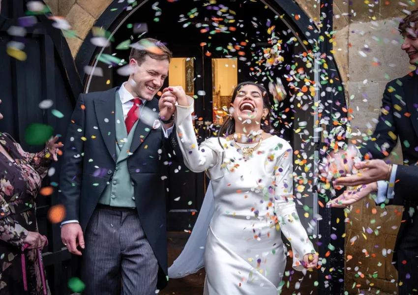The bride and groom with confetti