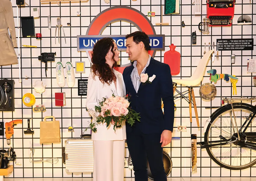 A couple standing in front of a selection of iconic design items