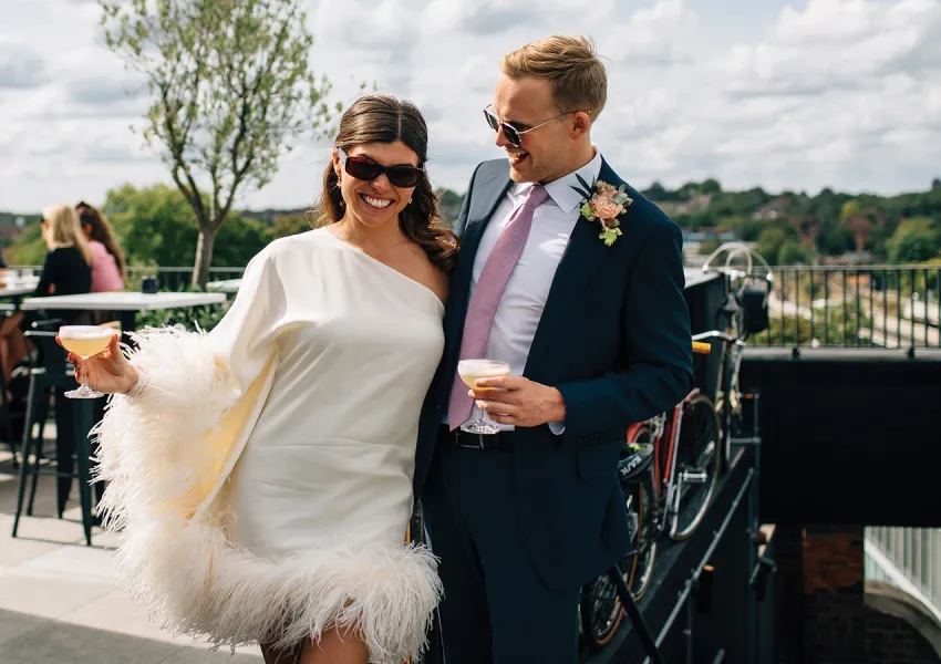 A stylish bride and groom in sunglasses