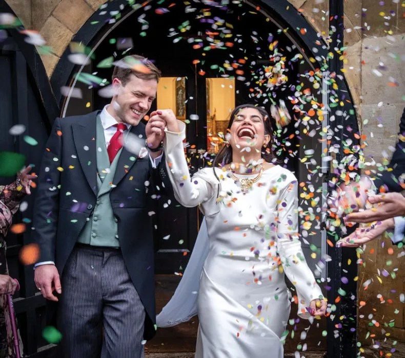 The bride and groom with confetti