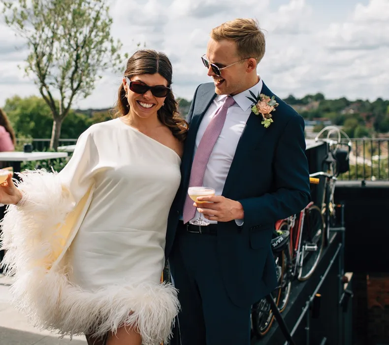 A stylish bride and groom in sunglasses