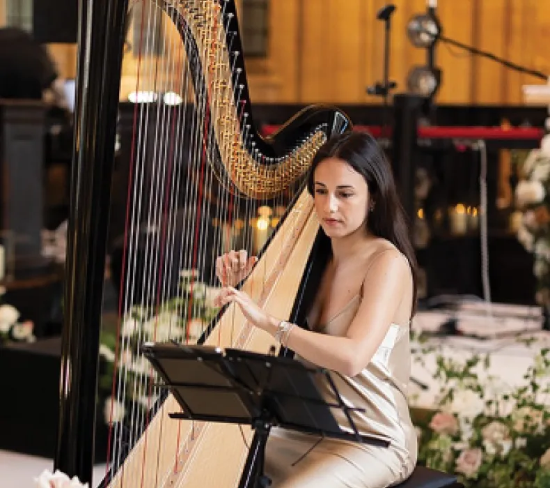 A woman playing a harp