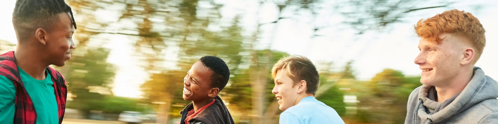  a group of teen boys smiling outdoors