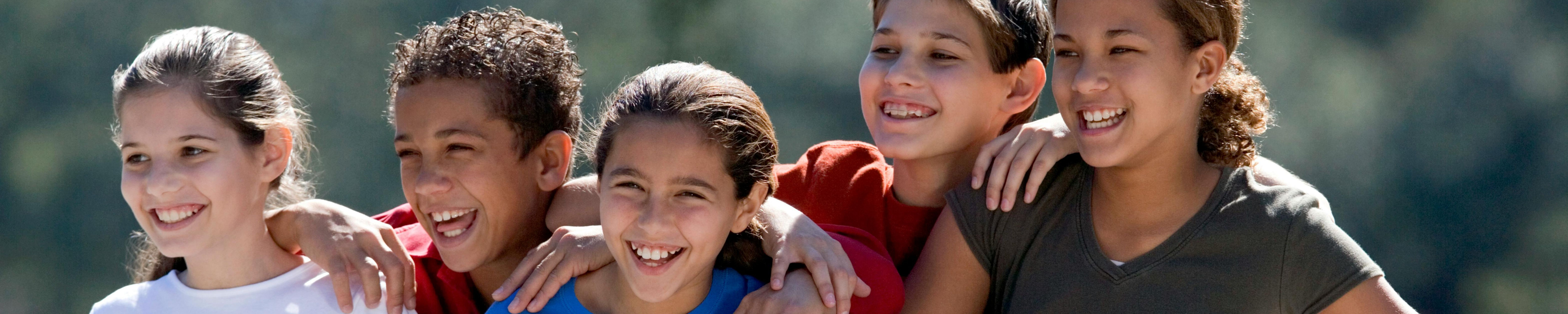  a group young girls smiling on a tennis court