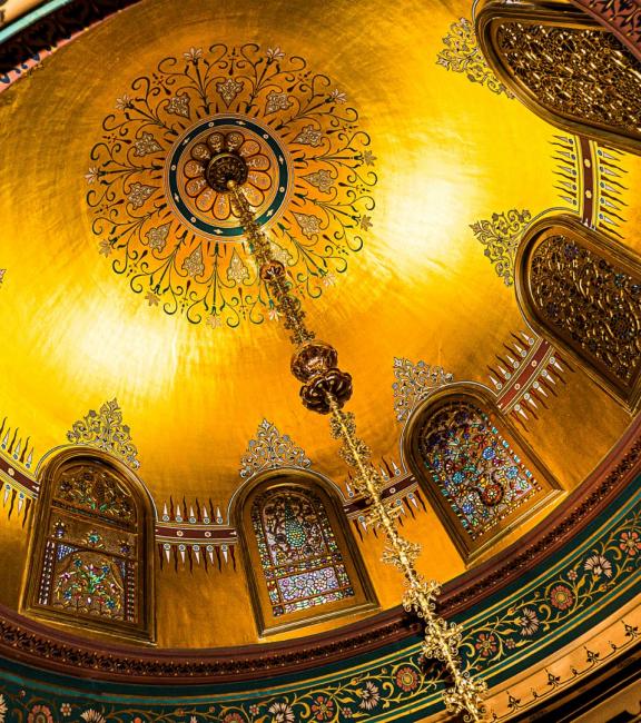 Golden dome with stained glass and chandelier
