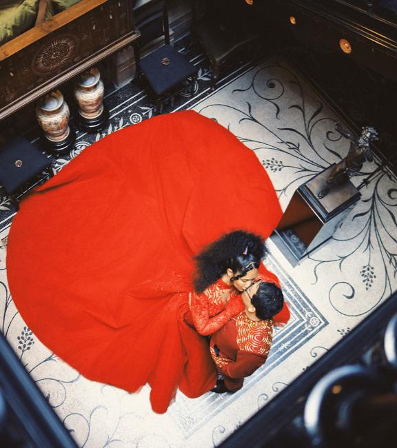A couple wearing red in Staircase Hall 