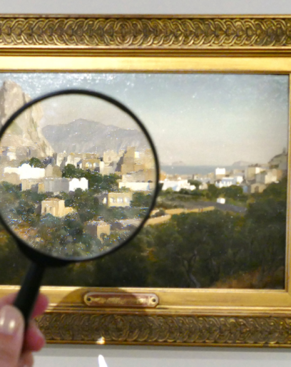 Looking at a painting with a magnifier glass