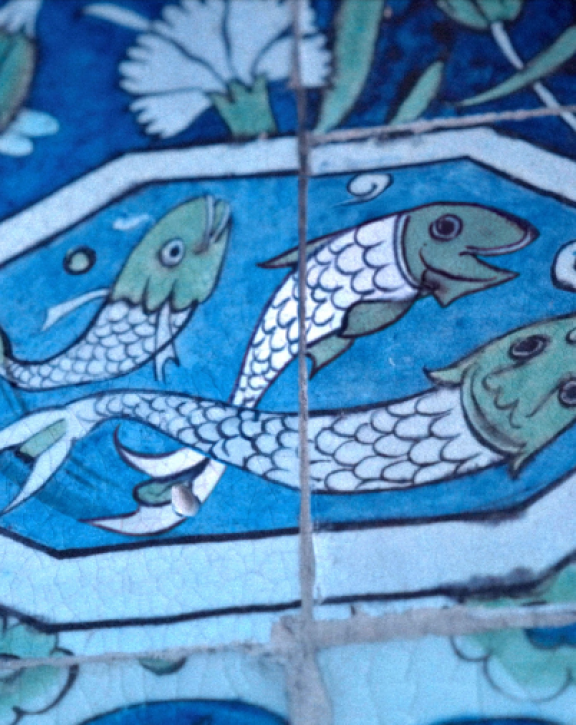 Soudade Kaadan and Nadine Kaadan with an image of a fish tile in the Arab Hall