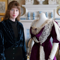 Curator Hannah Lund with historical dress at Sambourne House