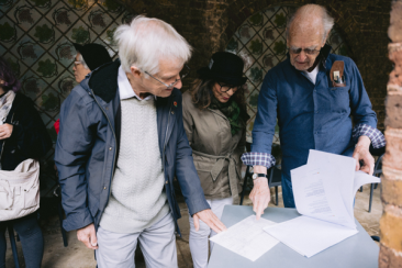 Group of older residents reviewing papers during an activity